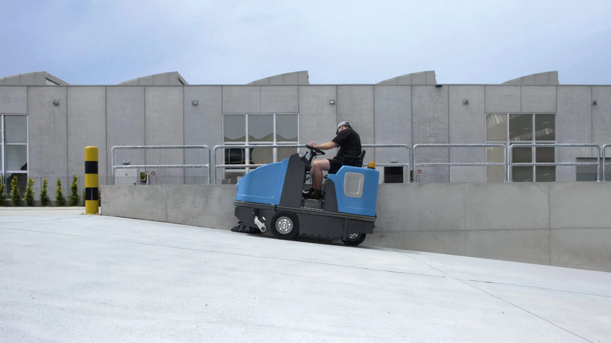 Commercial sweeper machine cleaning a Gold Coast site