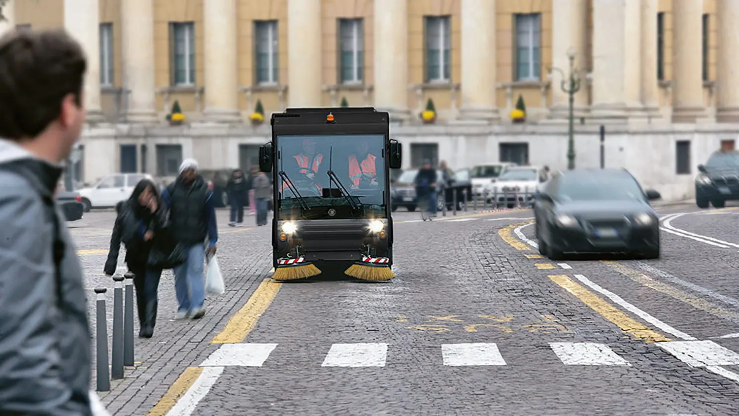 Road sweeper machine cleaning a kerb line